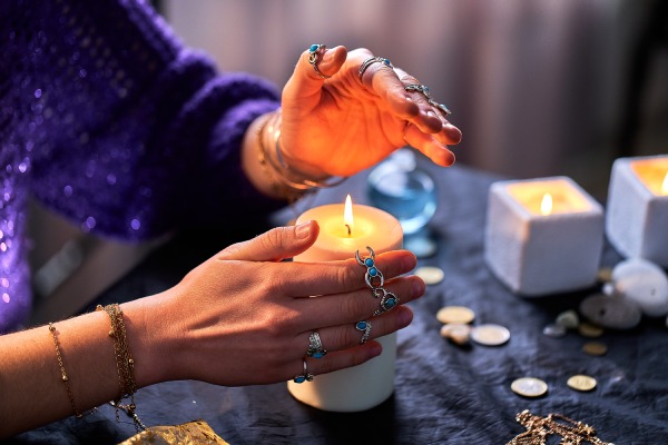 woman using burning candle